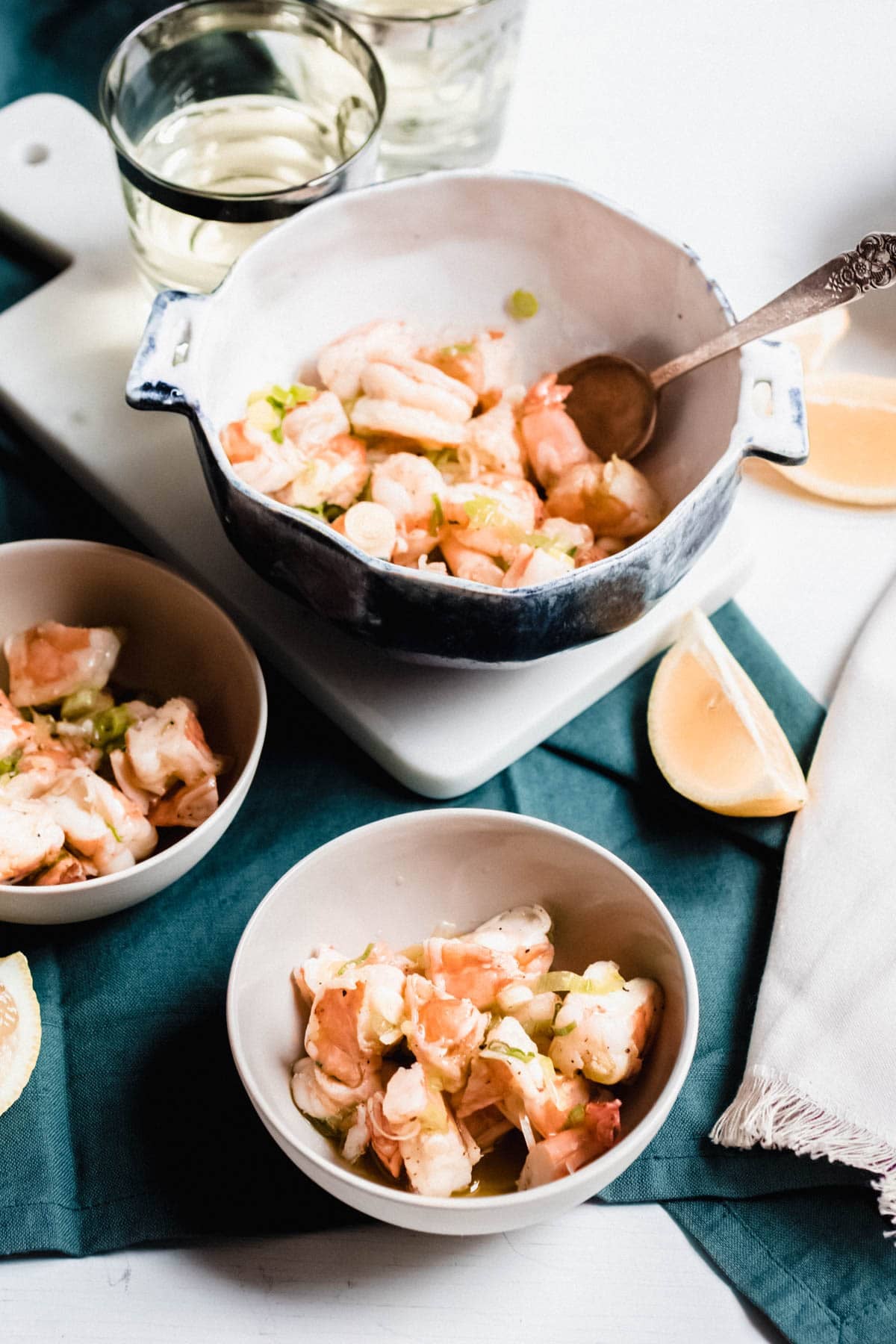 three bowls of shrimp salad on a table