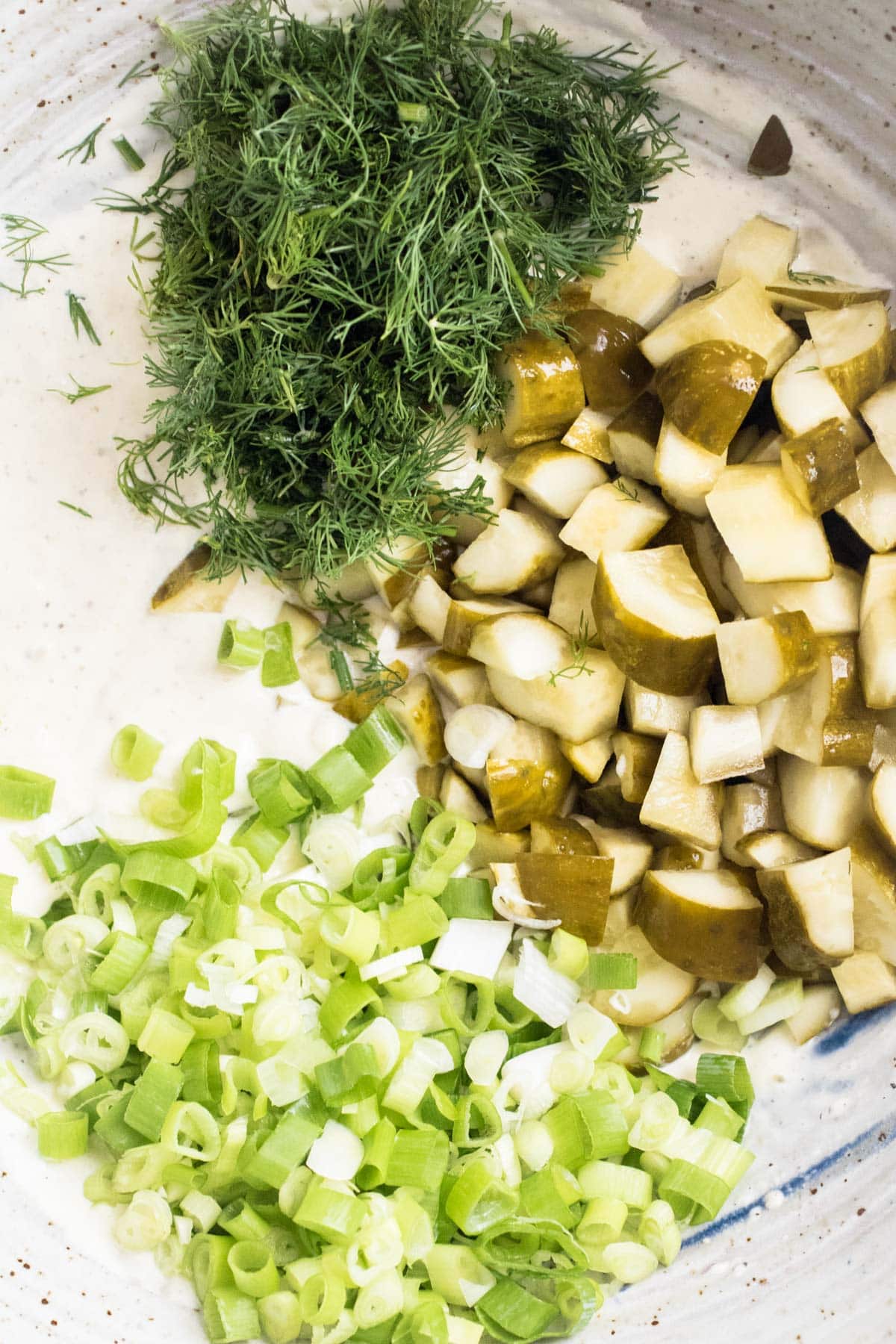 chopped ingredients for pickle potato salad in a bowl