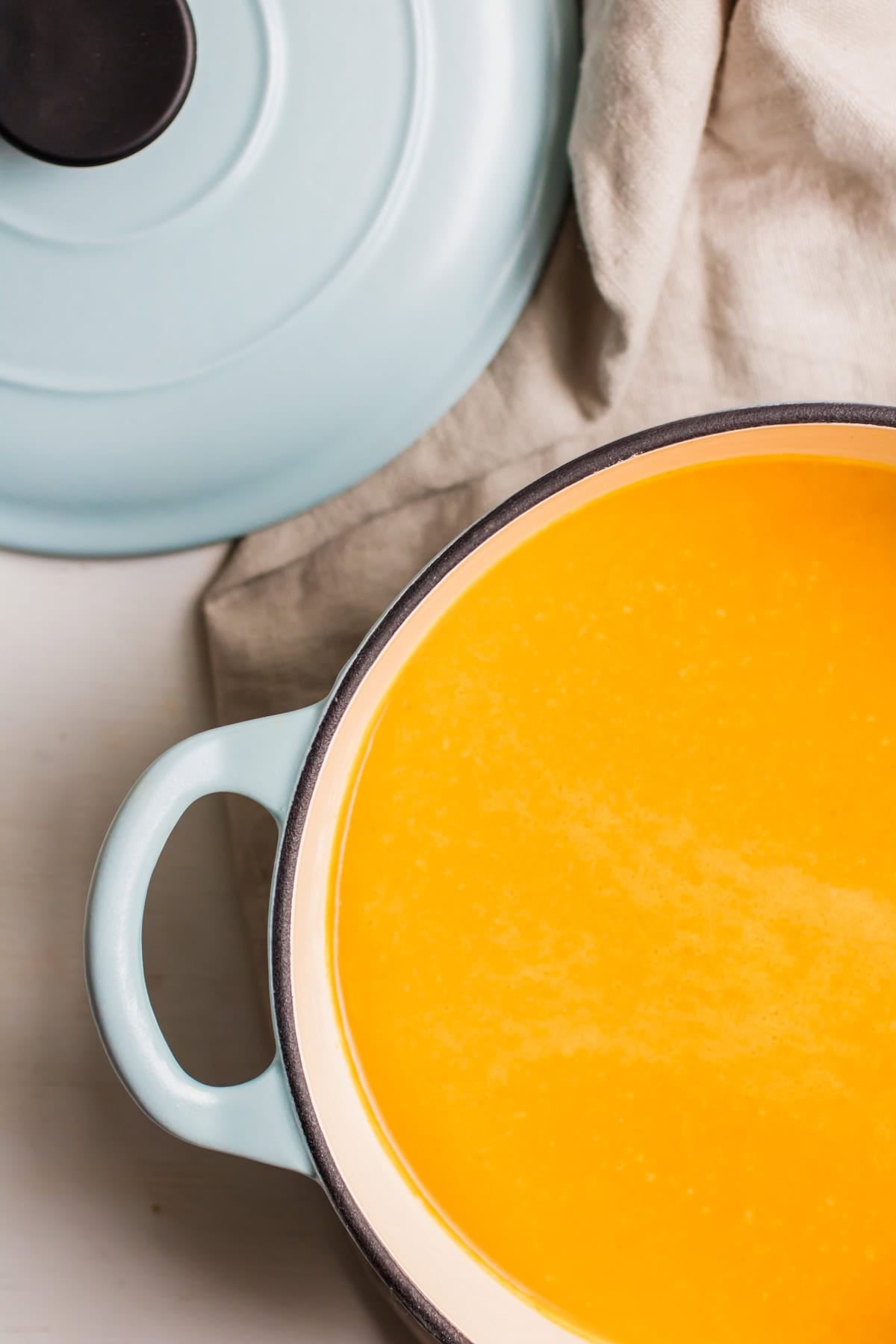 top down view of carrot soup in a large pot