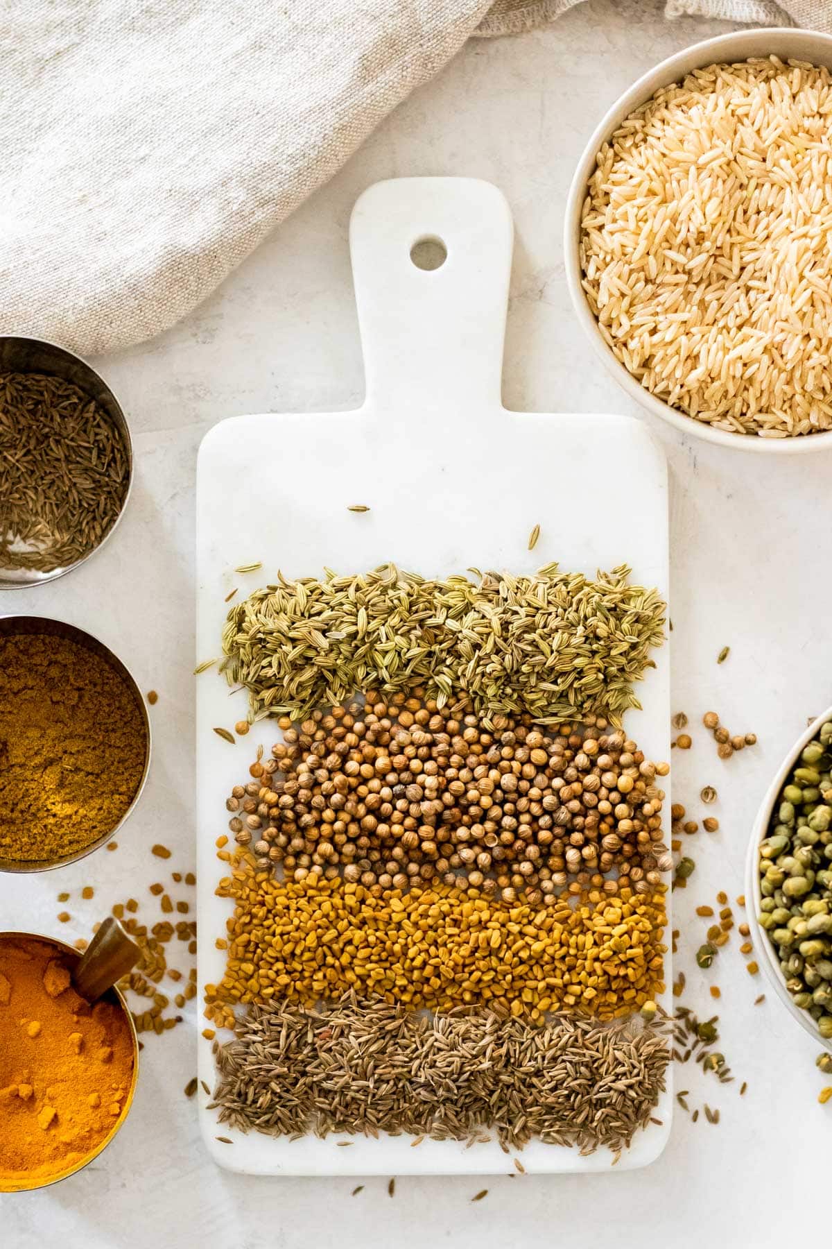 different seeds on a cutting board with spices