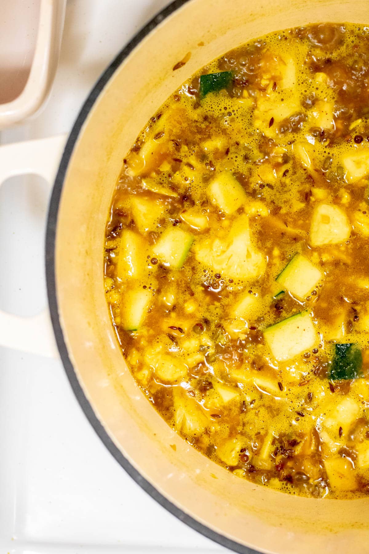 cooking vegetables in spiced ghee mixture