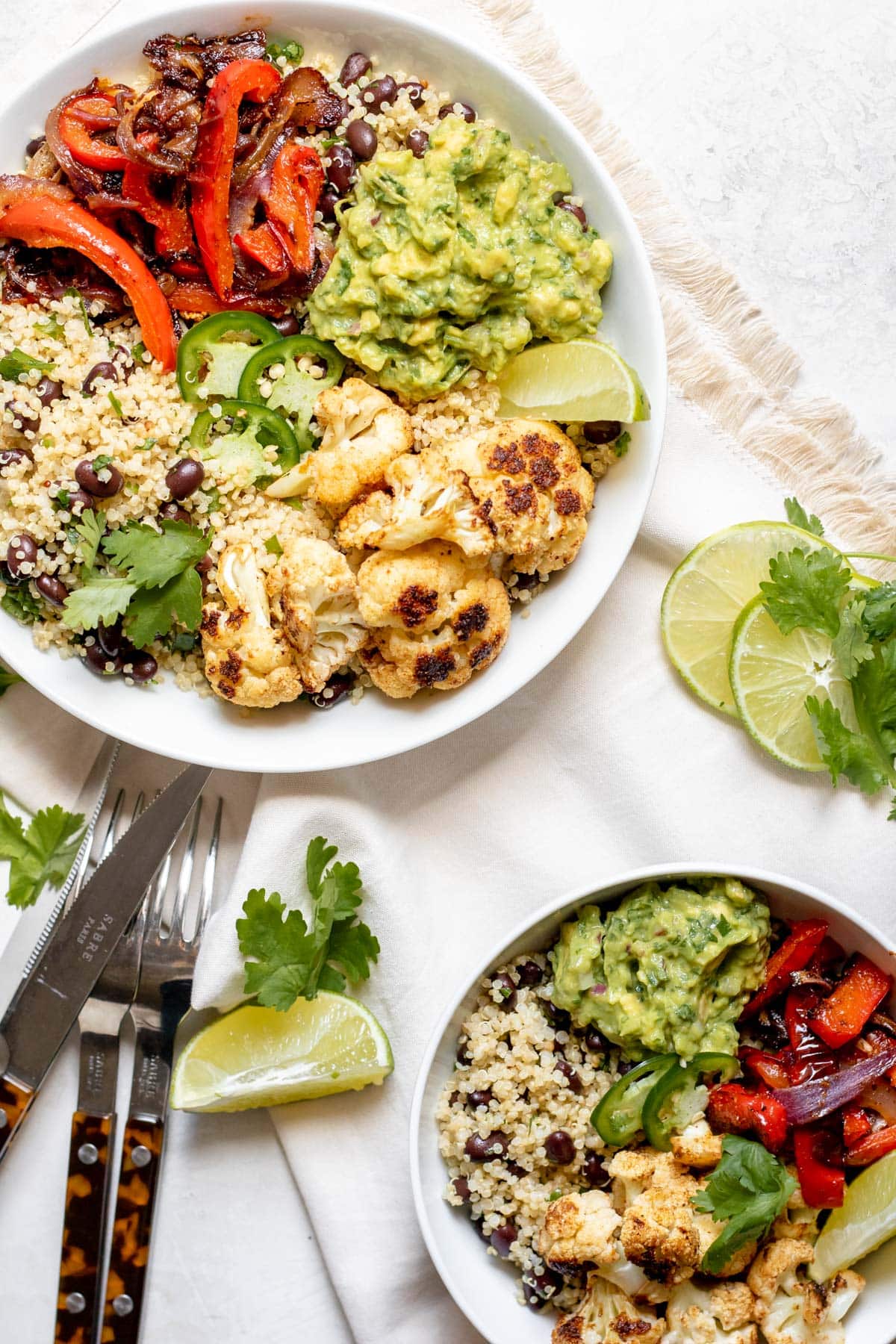 roasted veggies, quinoa, black beans and guacamole in a bowl