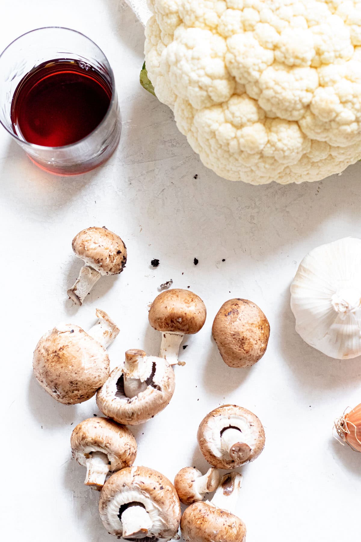 mushrooms, garlic, cauliflower and wine on a table