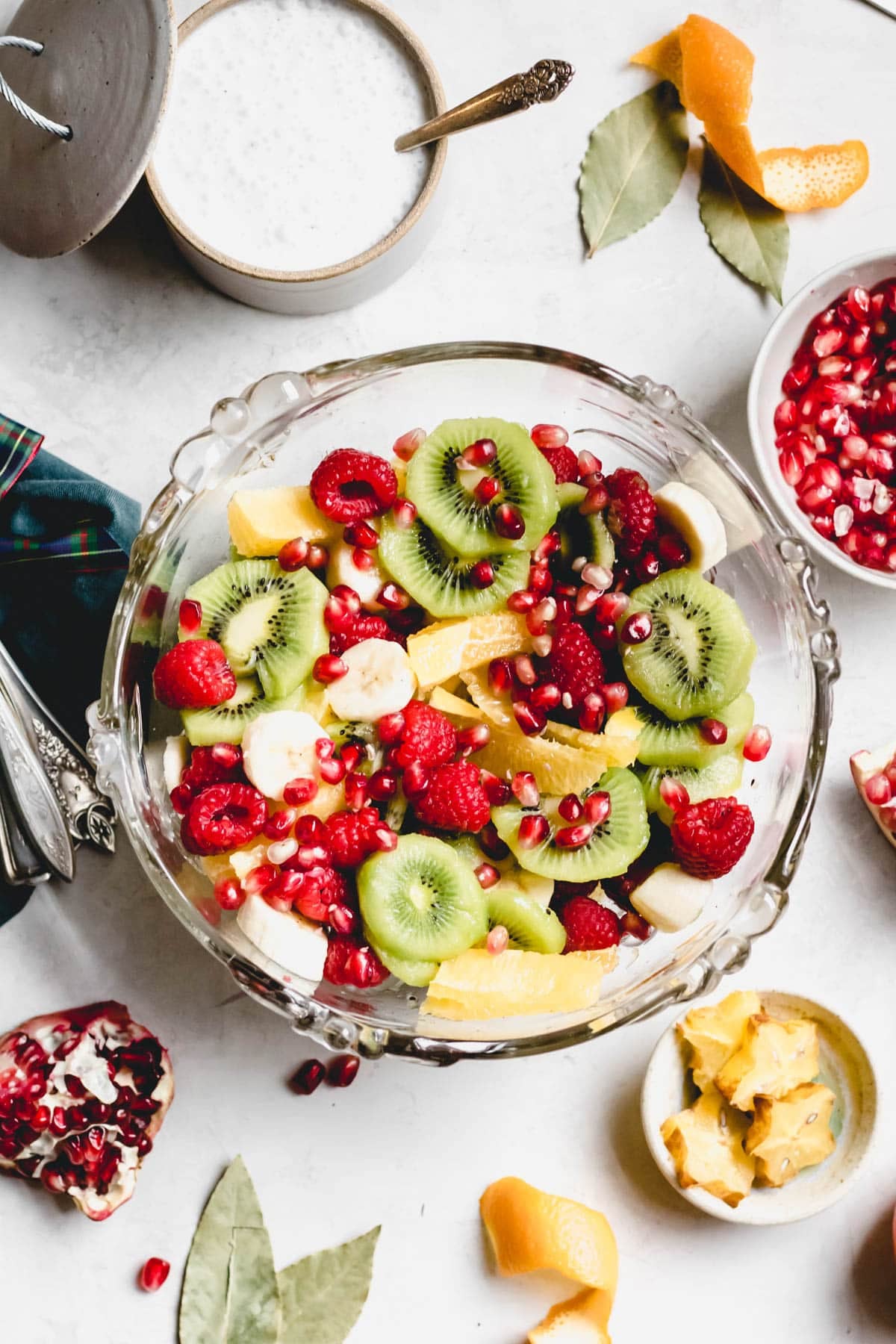 Christmas Fruit Salad in a large bowl with Egg Nog Sauce on the side