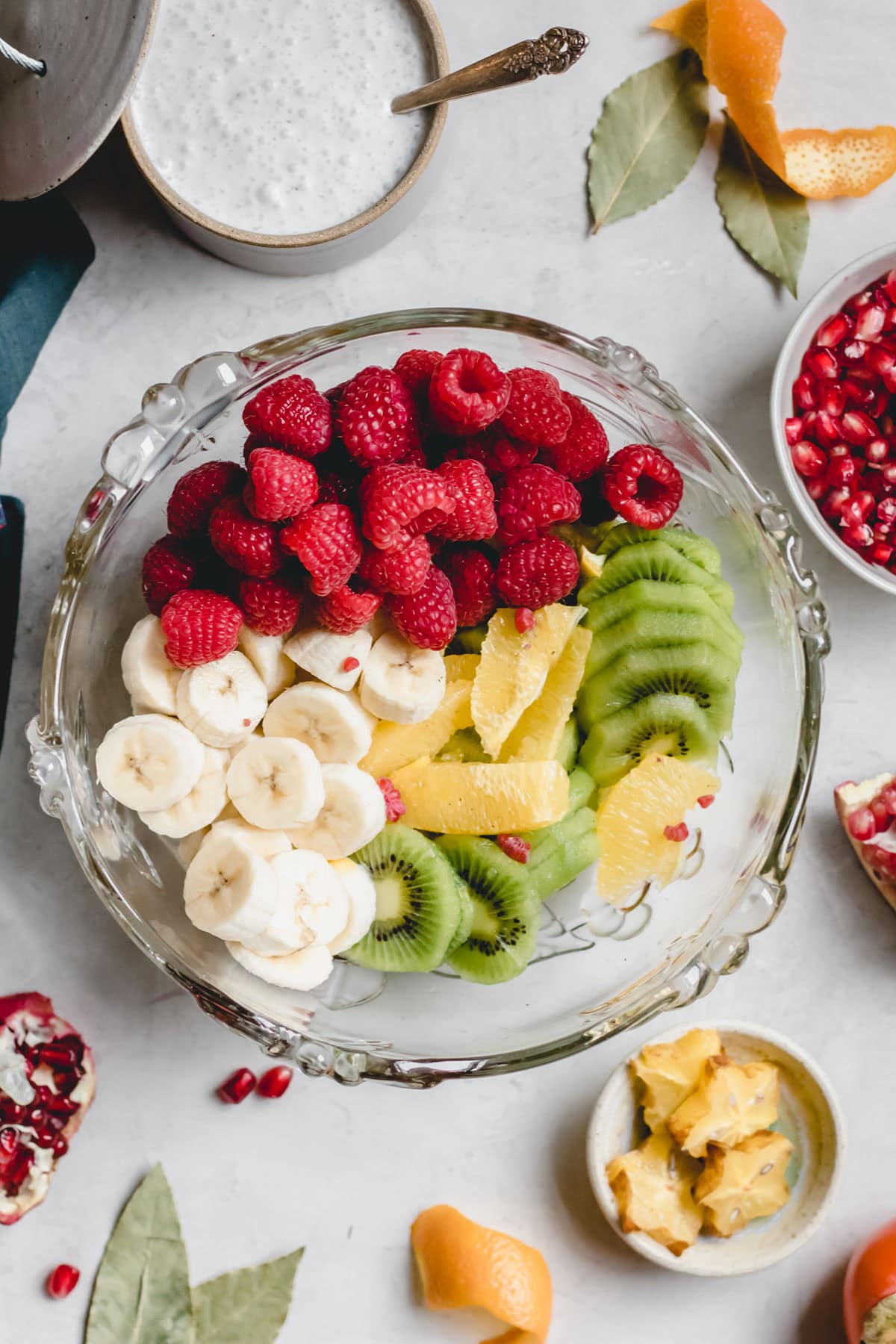 raspberries, sliced banana, kiwi and orange in a large bowl