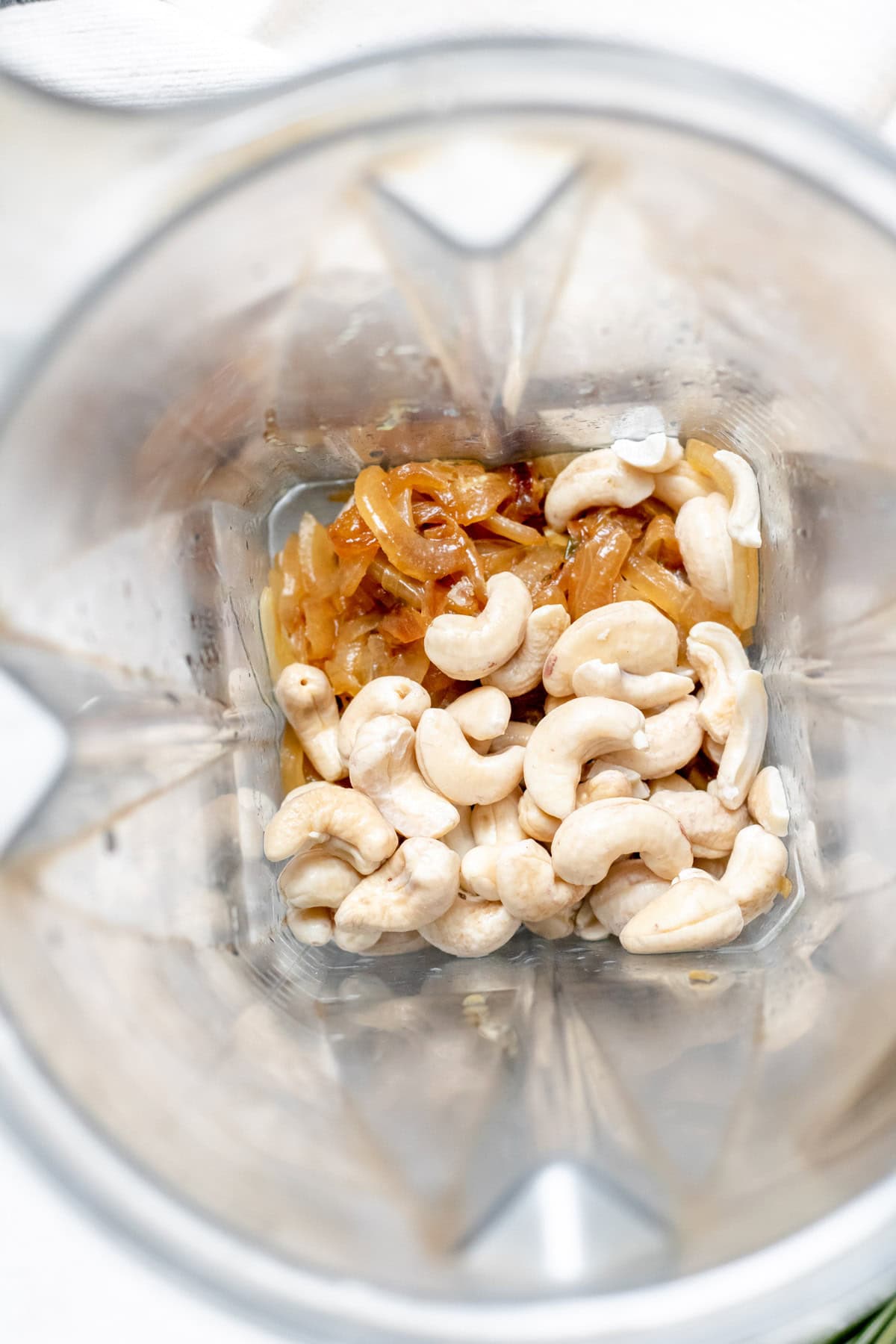 cashews and cooked onions in a blender
