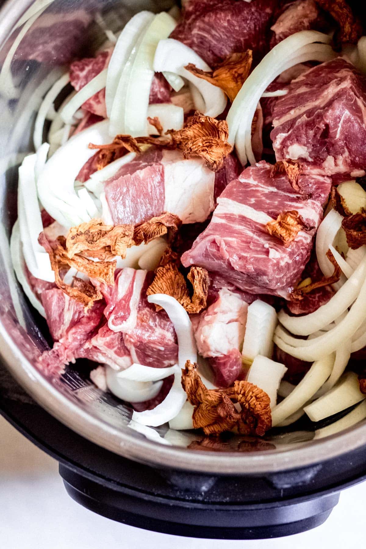 cubed beef and onion slices in an instant pot