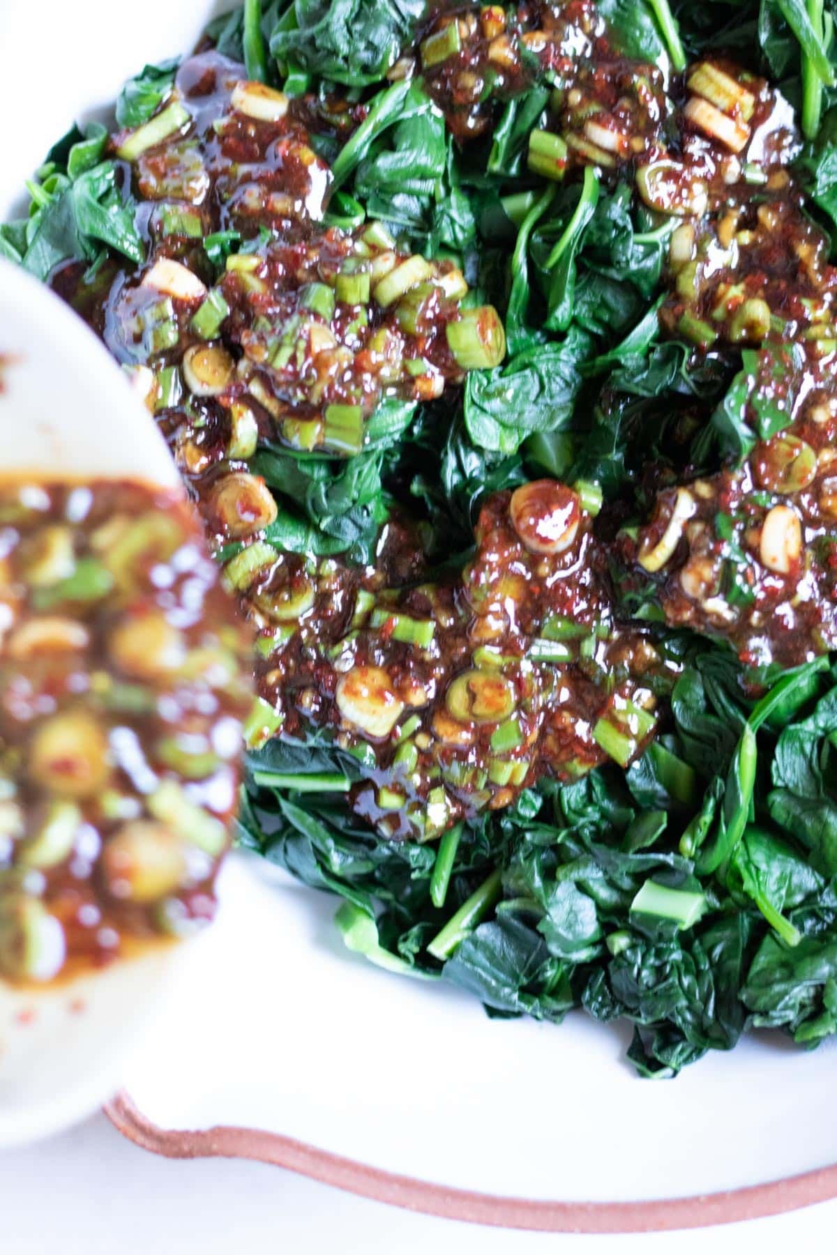 pouring marinade on top of leaves