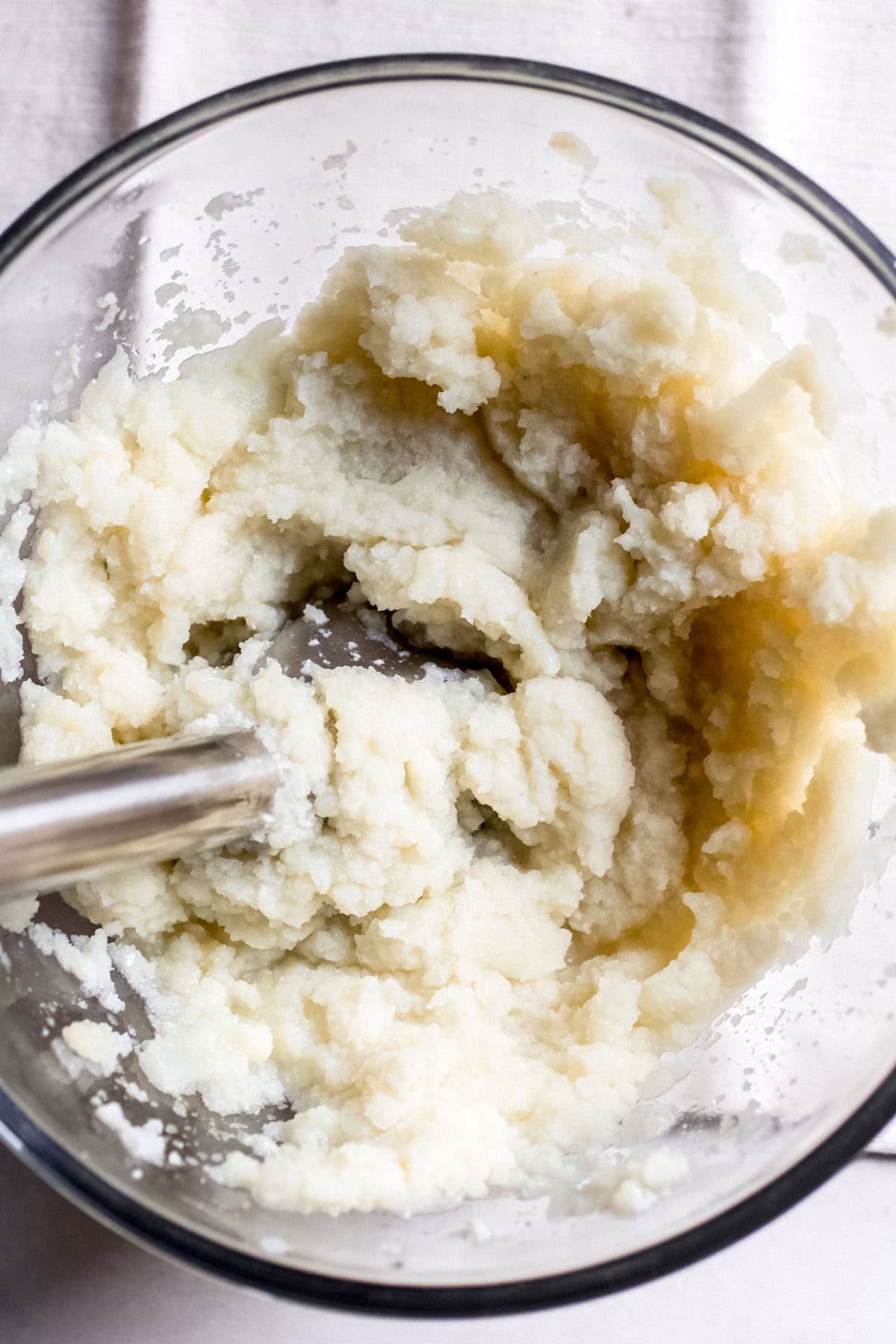 mashing steamed cauliflower
