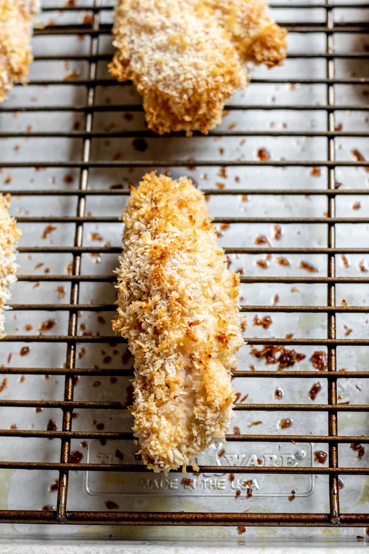 close up of breaded chicken slices on a wire rack