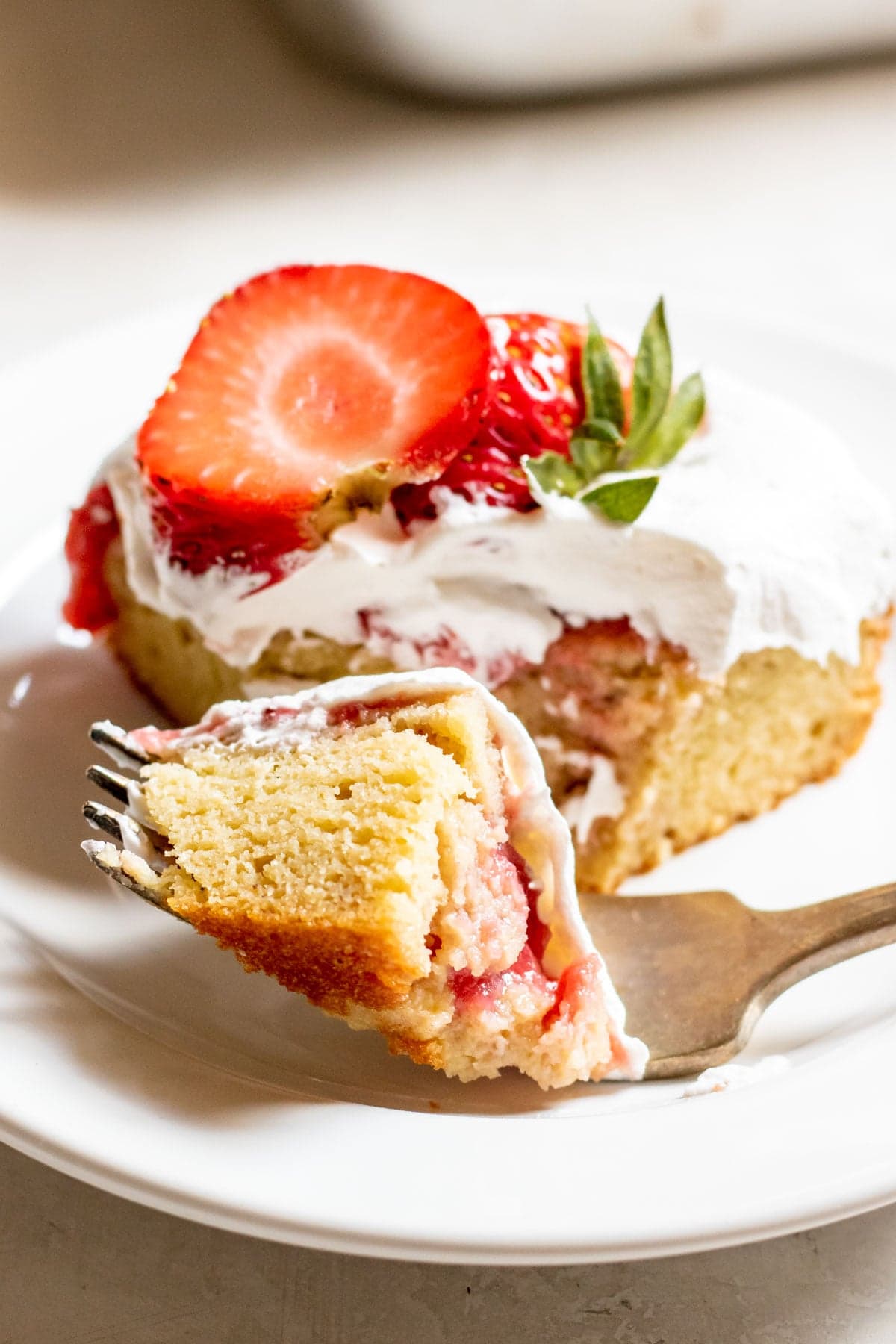 a forkful of Strawberry Poke Cake