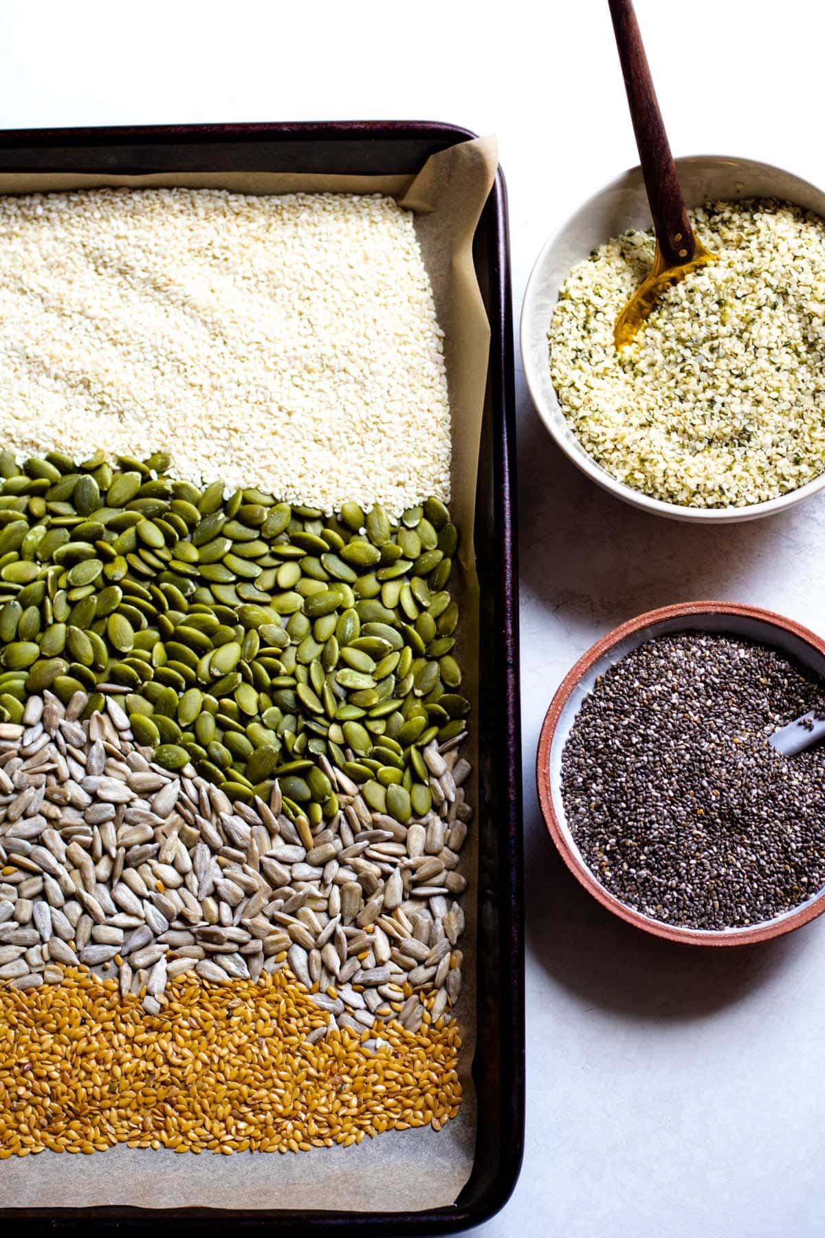 multiple types of seeds in a large baking tray