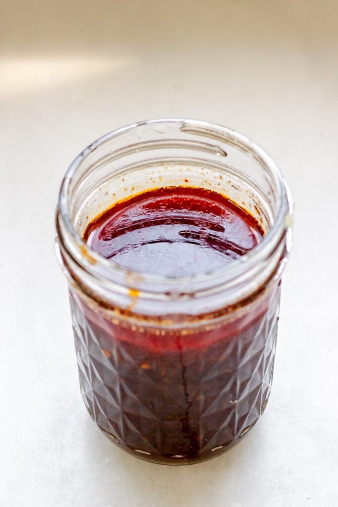 lime garlic ginger dressing in a glass cup
