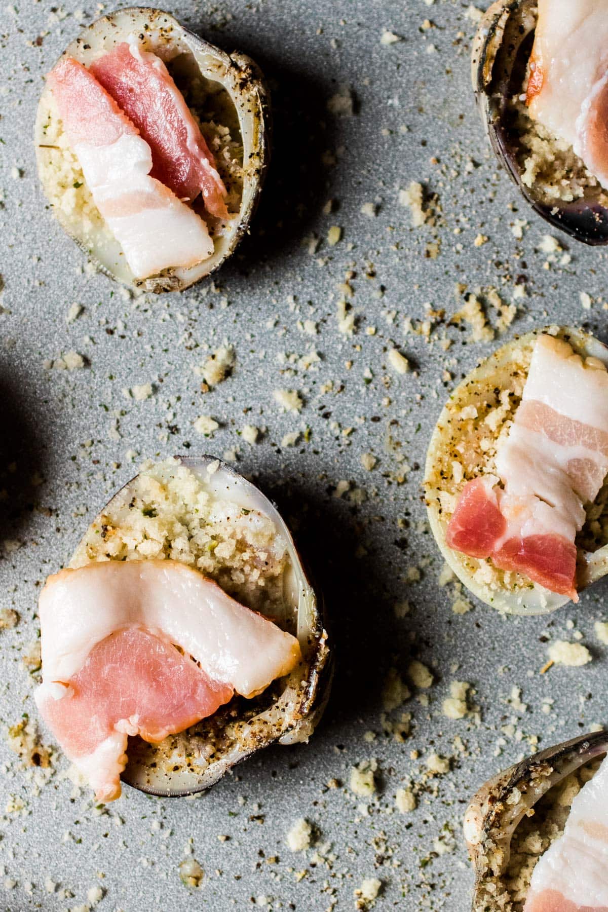 bacon pieces on top of the clams