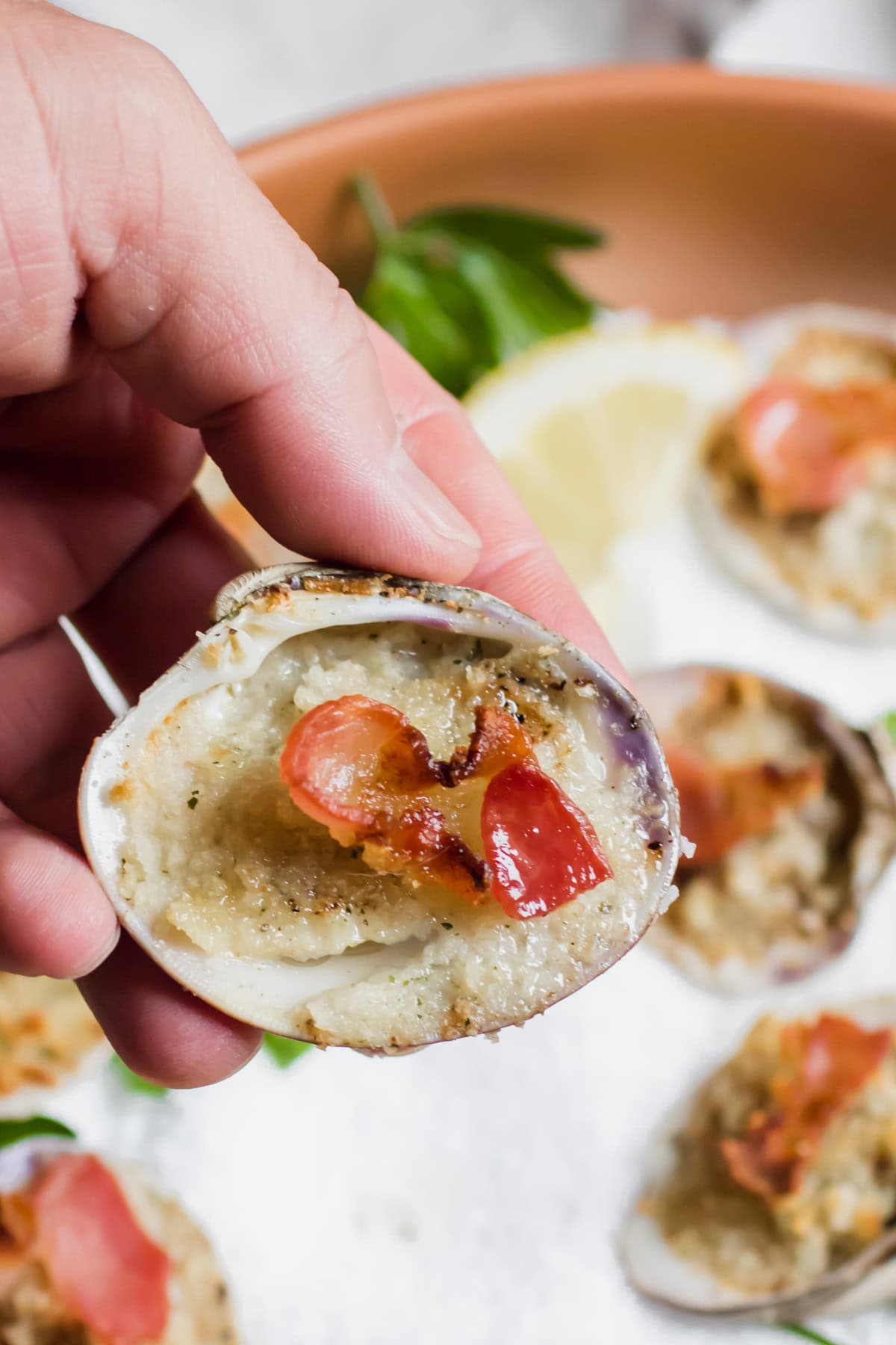 hand picking up a Clams Casino