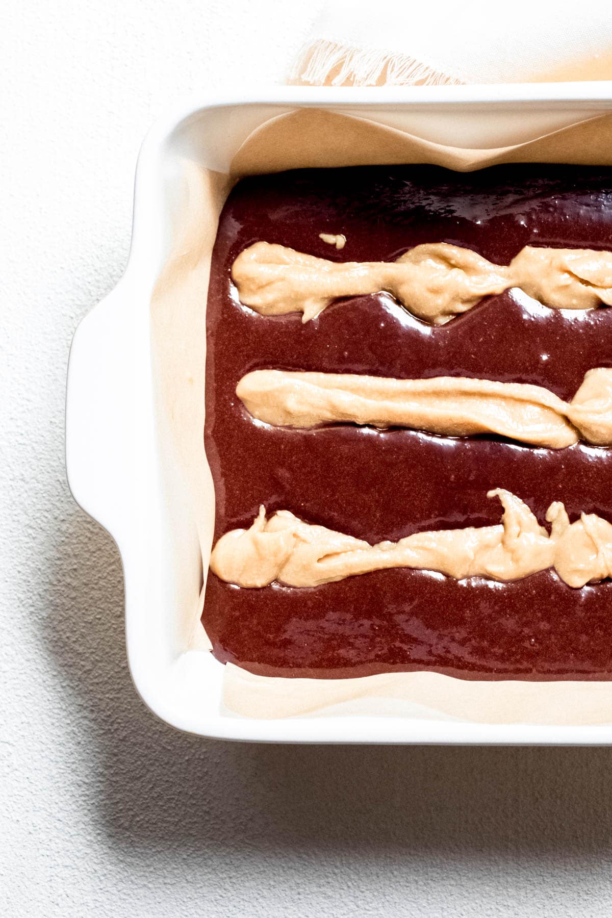 tahini stripes on top of the batter