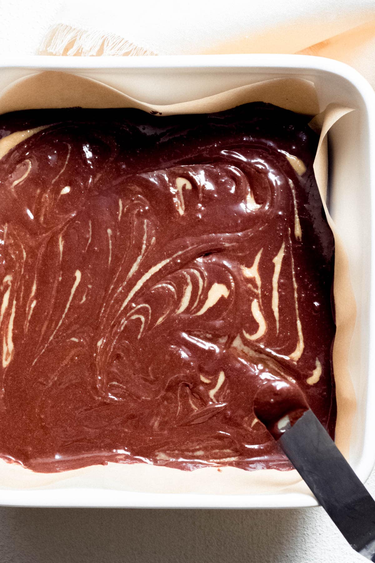 raw bownie batter in an oven dish