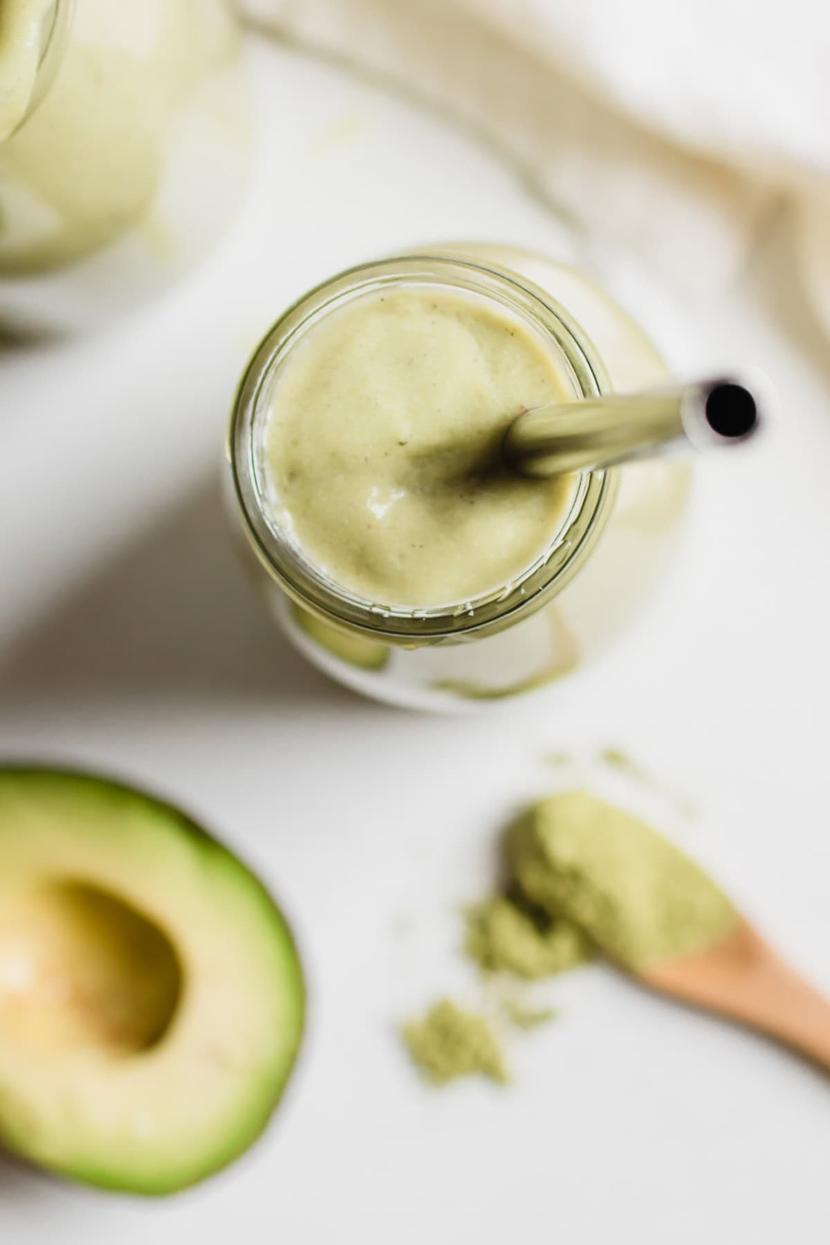 top down view of smoothie glass with a metal straw
