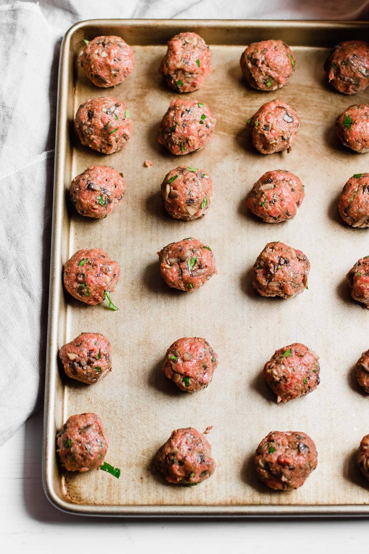 raw mushroom beef Meatballs on a baking tray