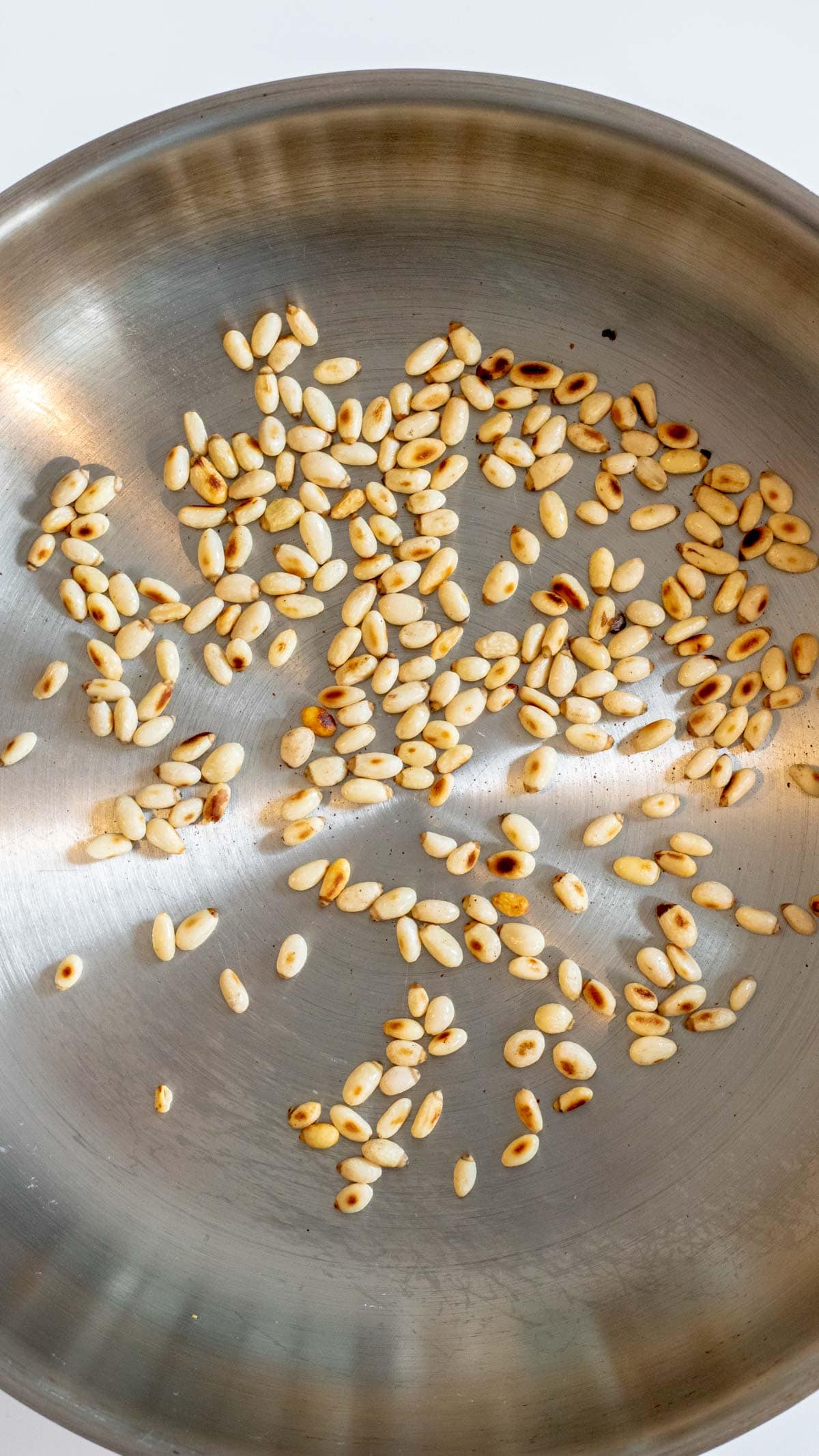 toasted pine nuts in a pan