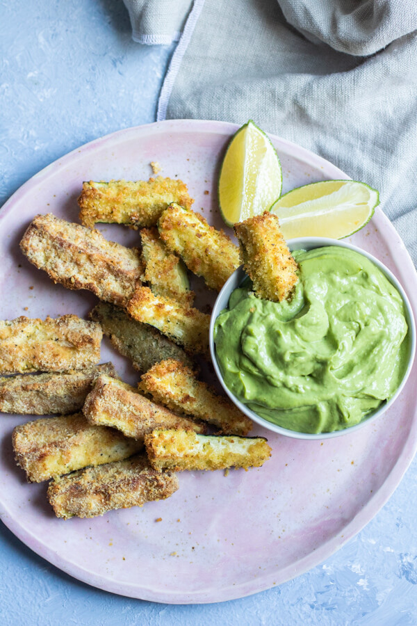 Crispy zucchini fries baked in the air fryer. A gluten-free, paleo version plus a more traditional bread crumb version. A crispy healthy snack, ready in 15 minutes!