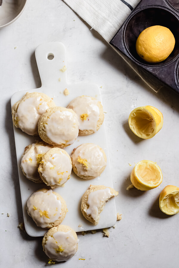 Lemon Cream Cheese Cookies with Almond Flour on a white board with lemons