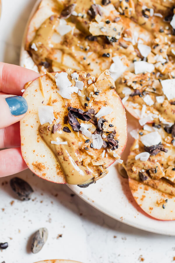 Healthy Apple Nachos! Sliced apples topped with creamy sunflower seed butter, cinnamon, coconut, and crunchy seeds,  the perfect fall treat! A healthy after-school snack or mid-morning break that takes less than 5 minutes to put together.