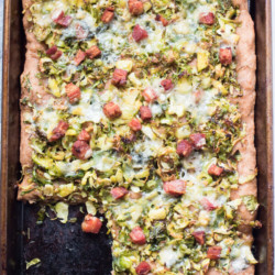 Insanely delicious Brussels sprout pizza with crispy bacon and crumbled blue cheese. 5 ingredients, 20 minutes, one sheet pan. Pizza perfection. |Abraskitchen.com
