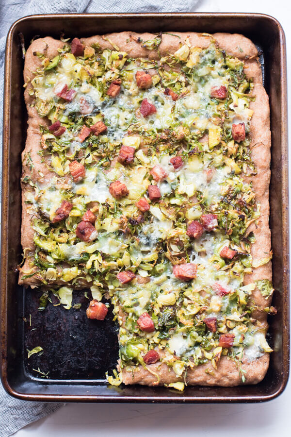 Insanely delicious Brussels sprout pizza with crispy bacon and crumbled blue cheese. 5 ingredients, 20 minutes, one sheet pan. Pizza perfection. |Abraskitchen.com