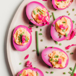 An easy delicious recipe for gorgeous beet pickled deviled eggs. Traditional pickled eggs turned into mouthwatering deviled eggs. The perfect healthy snack or delicious appetizer for a crowd.