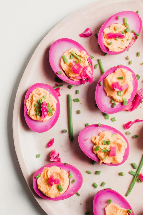 An easy delicious recipe for gorgeous beet pickled deviled eggs. Traditional pickled eggs turned into mouthwatering deviled eggs. The perfect healthy snack or delicious appetizer for a crowd.