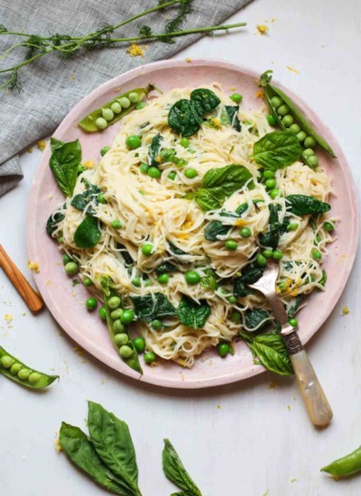 Creamy Vegan Lemon Pasta with Fresh Peas and Spinach, ready in under 30 minutes! Simple to make and full of good for you ingredients.