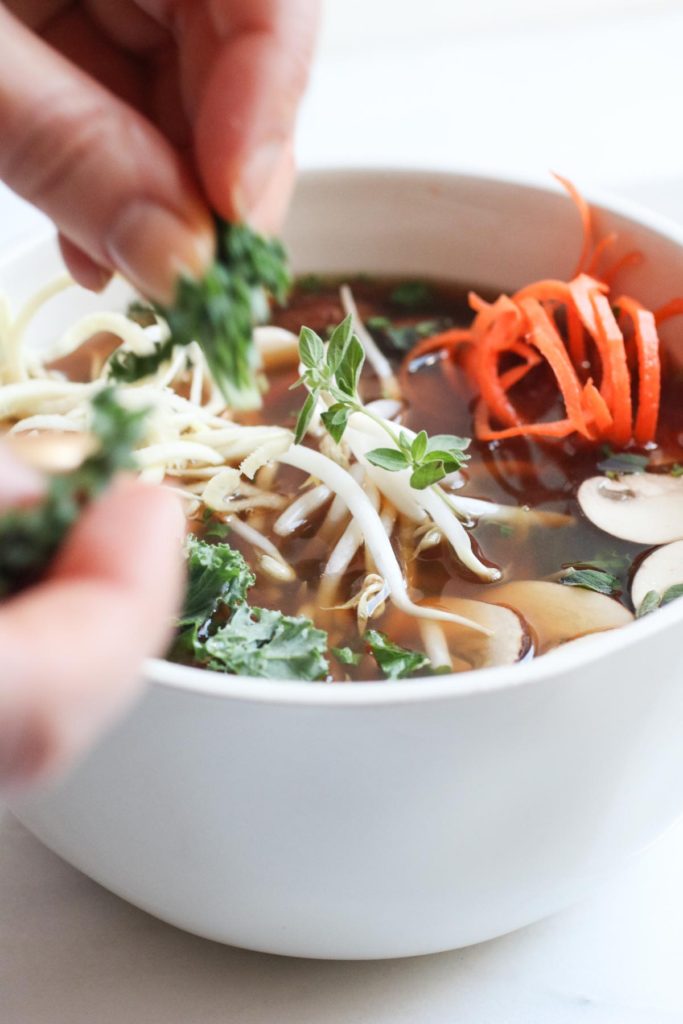 Detoxifying broth bowls with parsnip and carrot noodles is a paleo and gluten free meal that is chocked full of anti-inflammatory, nutrient dense veggies. Healthy, quick, and super yummy! abraskitchen.com