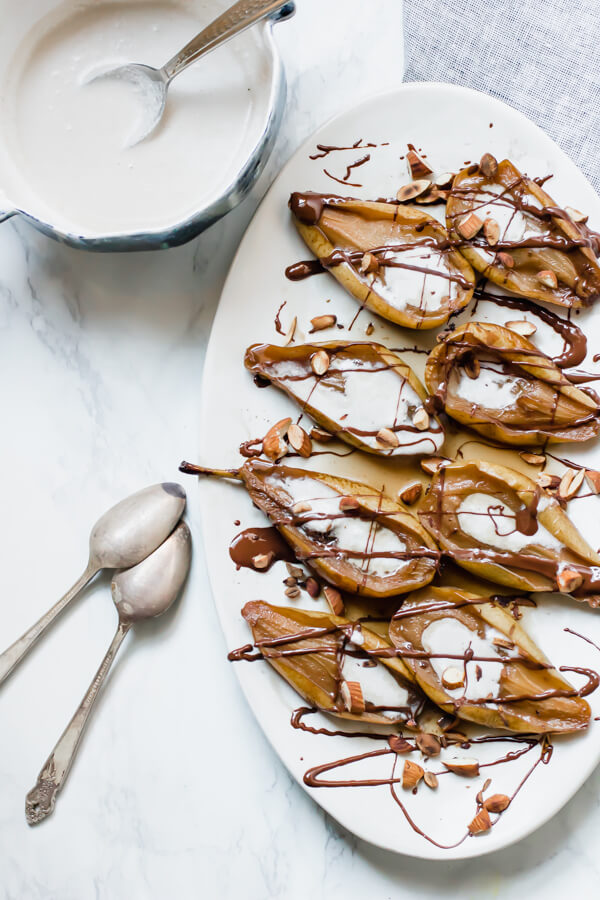 Earl Grey Poached Pears with Warm Chocolate Sauce and a coconut cream drizzle is an insanely delicious, quick and easy, healthy dessert. Perfect for the holidays. Paleo, gluten-free, and vegan.