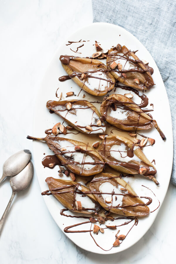 Earl Grey Roasted Pears with Warm Chocolate Sauce and a coconut cream drizzle is an insanely delicious, quick and easy, healthy dessert. Perfect for the holidays. Paleo, gluten-free, and vegan.