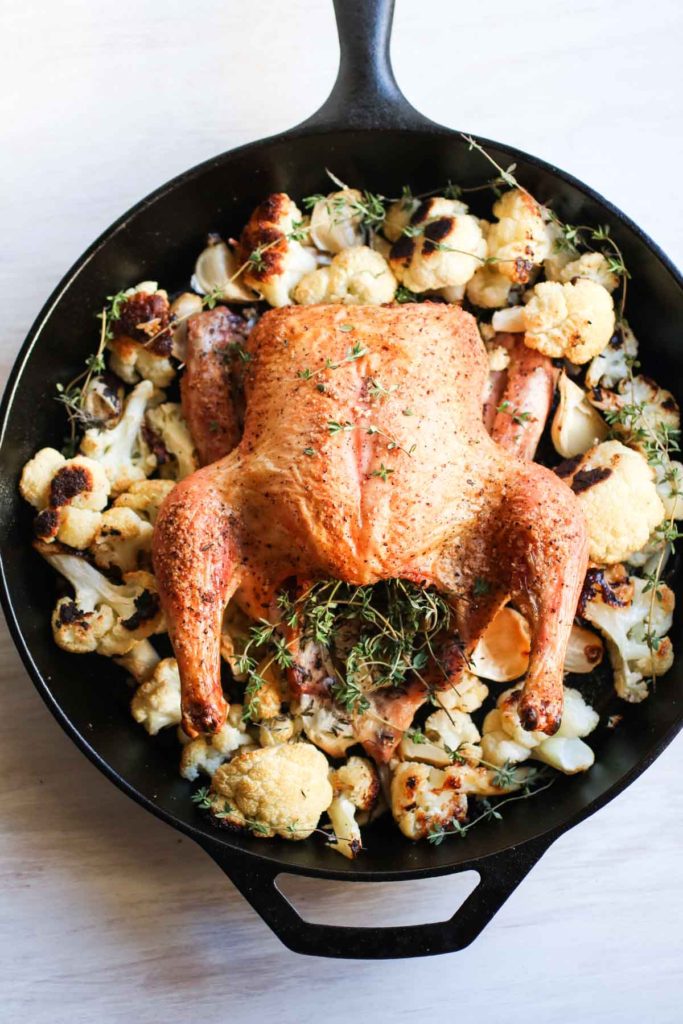 One pan easy garlic thyme roast chicken with cauliflower is the one recipe you need and the only recipe you will every use for whole roasted chicken. Perfect every time, crispy skin, juicy and flavorful. A complete meal made in a cast iron skillet. 