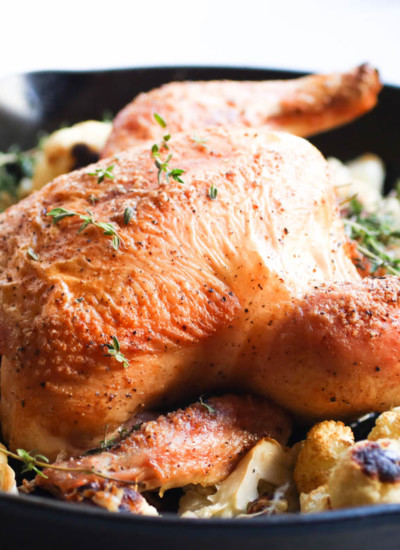 One pan easy garlic thyme roast chicken with cauliflower is the only recipe you will ever need for whole roasted chicken.Cast Iron Skillet, Paleo, Gluten Free |abraskitchen.com