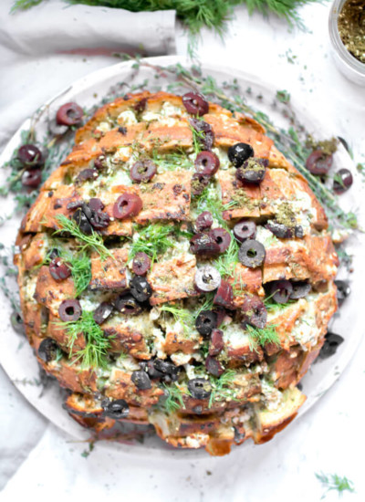 Feta Cheese and Olive Pull Apart bread, ooey gooey cheesy bread with briny salty olives, fresh herbs, and garlic, and it is in all ways amazing! The perfect appetizer to serve to a large crowd.