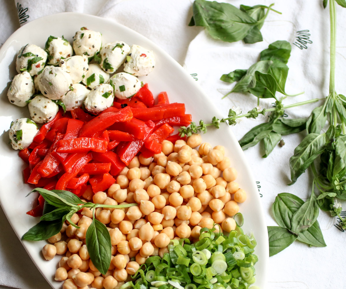 Fresh Basil and Roasted Cauliflower pasta salad - with pasta, roasted cauliflower, fresh mozzarella, chickpeas, roasted bell peppers, and tons of fresh basil. This is the easiest and healthiest vegetarian pasta salad. | abraskitchen.com
