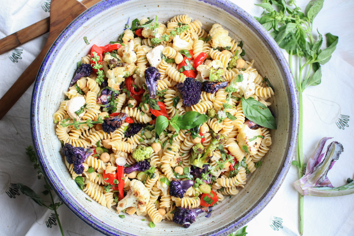 Fresh Basil and Roasted Cauliflower pasta salad - with pasta, roasted cauliflower, fresh mozzarella, chickpeas, roasted bell peppers, and tons of fresh basil. This is the easiest and healthiest vegetarian pasta salad. | abraskitchen.com