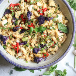Fresh Basil and Roasted Cauliflower pasta salad - roasted cauliflower, fresh mozzarella, chickpeas, roasted bell peppers, and tons of fresh basil. This is the easiest and healthiest vegetarian pasta salad. | abraskitchen.com