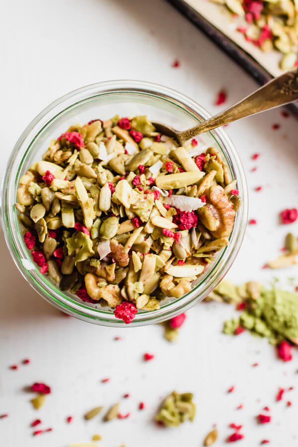 A super simple grain-free granola recipe with matcha green tea powder, coconut, and dried raspberries. Low carbohydrate, paleo friendly, vegan, and addictively good! 