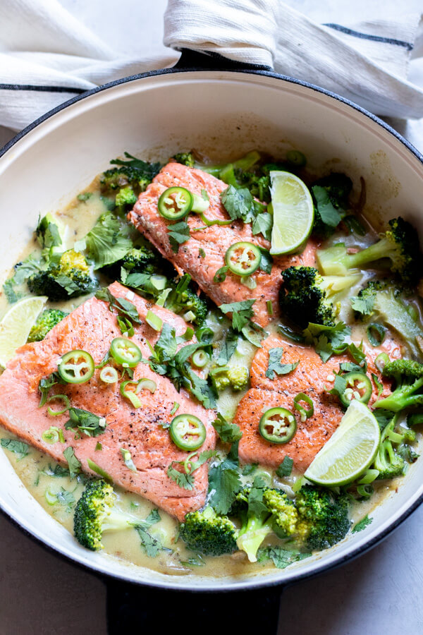 green curry salmon with broccoli in a pan