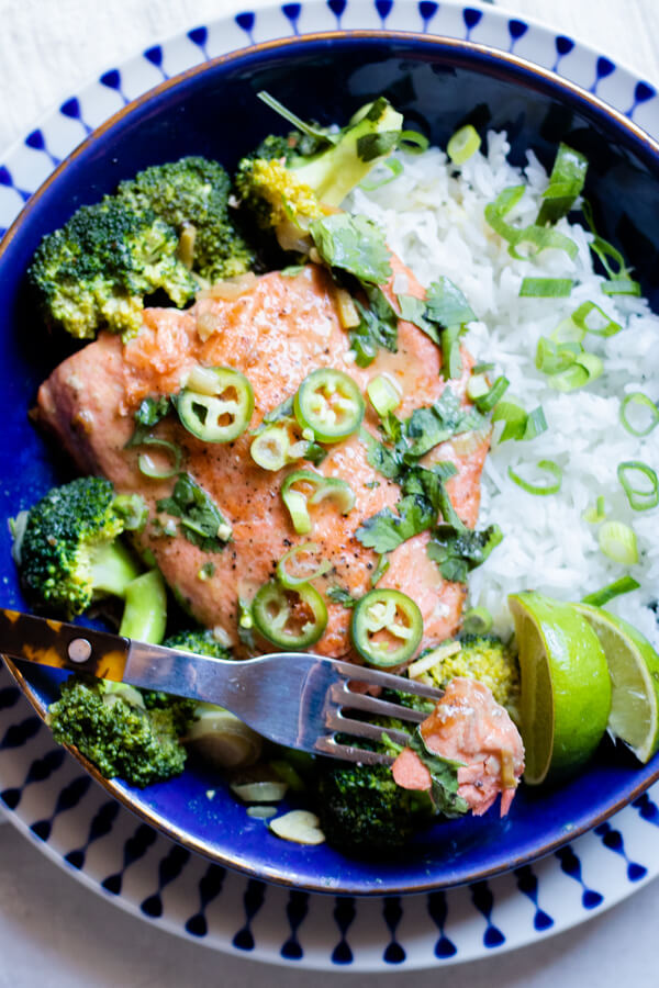 green curry salmon in a blue bowl with rice