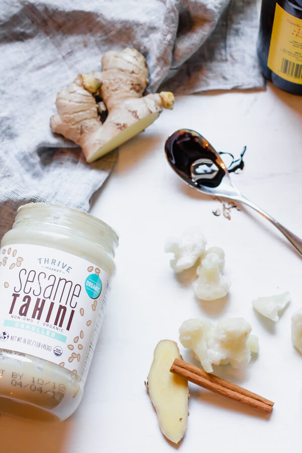 A creamy healthy smoothie that tastes like a gingerbread cookie! No fruit added, so this smoothie is low in sugar and high in protein. Perfect start to your day. Cauliflower Smoothie, Tahini, Spices. #Vegan #glutenfree #paleo #whole30 #healthysmoothie