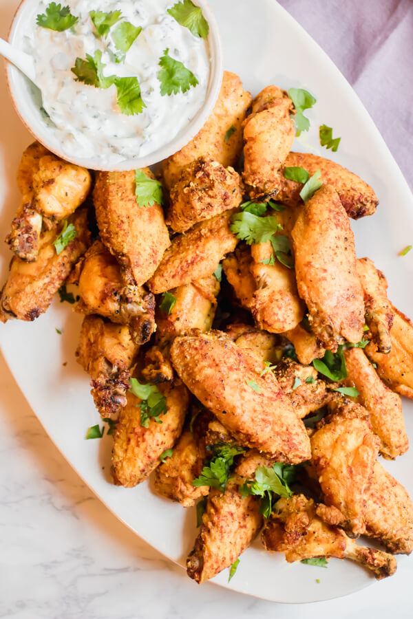 Healthy Oven Crisp Turmeric Black Pepper Wings with a tangy yogurt dipping sauce.