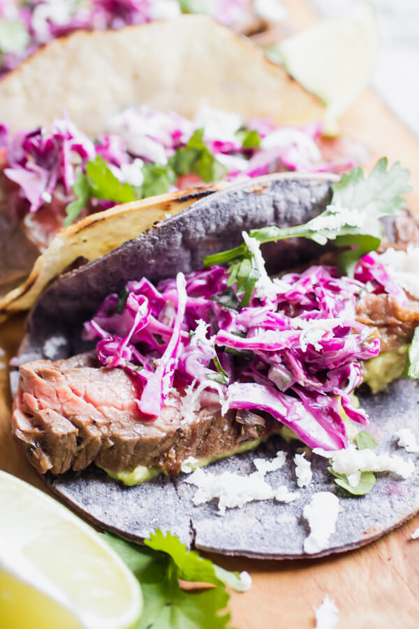 Quick and easy healthy steak tacos topped with a mouthwatering lime cilantro coleslaw. 