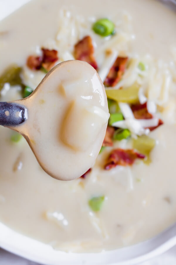 Hearty creamy potato soup with bacon and green chilis. The perfect bowl of soup to serve for a holiday open house. Comforting, and supremely delicious with a hint of earthy spice from the green chilis. This potato soup will quickly become a family favorite for holidays, parties, and just cozy Friday nights next to a fire.