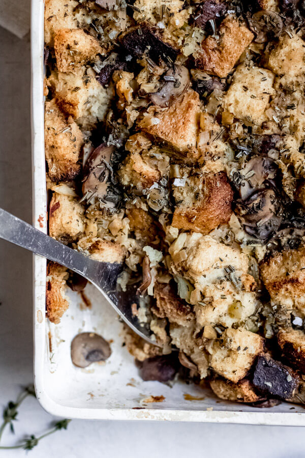 Sourdough Stuffing with Wild Mushrooms spoon taking a scoop out of stuffing