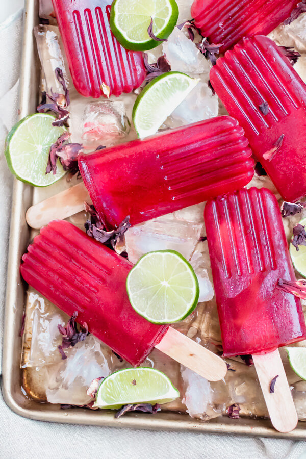 Refreshing and hydrating Hibiscus Lime-Aid Popsicles. Requires only four wholesome ingredients, sweetened with raw honey.
